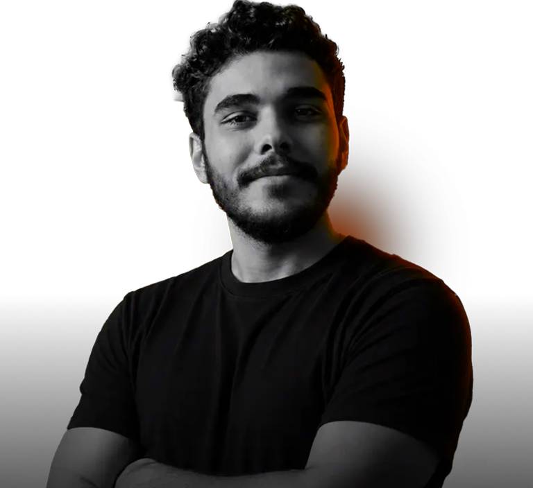 Omar Hosam, arms crossed, studio portrait with kinetic orange rim light